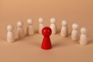 red pawn separated to showcase leadership succession planning concept